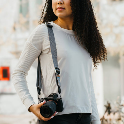 Anne using her Ash Slide Lite with her camera as shoulder carry